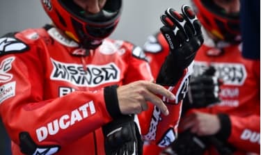 Ducati rider putting on gloves